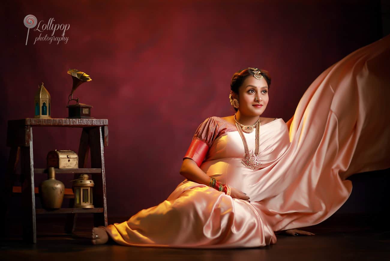 Traditional maternity photoshoot in Chennai with a mother-to-be dressed in a beautiful saree, creating a timeless and elegant portrait.